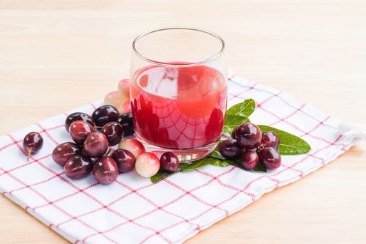 fresh Carissa carandas glass of juice with Carissa carandas fruits and Healthy drinks concept
