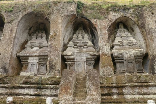 Udayana Dynasty Royal Tombs. Ancient royal tombs at Gunung Kawi Temple. Funeral complex centered around royal tombs carved into stone cliffs in the 11th century. Bali, Indonesia.