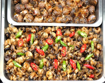 Fried sea snails with red and green hot chili