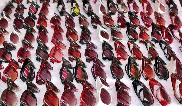  An outdoor vendor sells cheap no-brand sunglasses.
