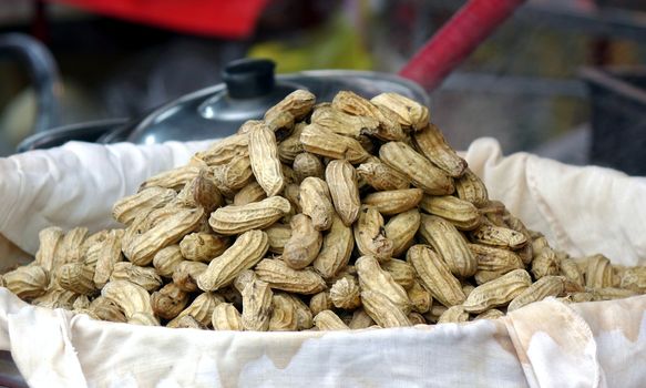A bamboo tray with steamed peanuts at a Chinese market