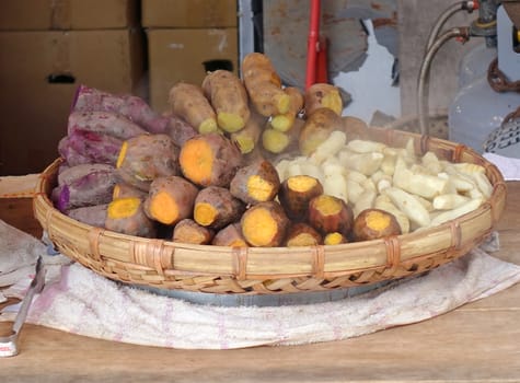 A street vendor sells steamed yams and sweet potatoes
