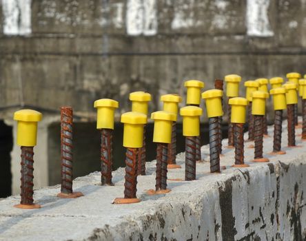 Rebar steel rods with yellow end protection caps
