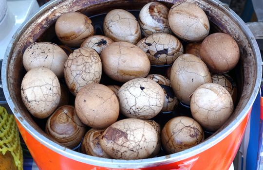 A vendor sells tea eggs that have been cooked in a brew of spices and tea leaves

