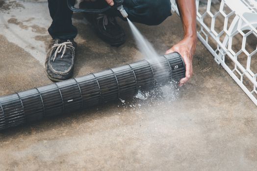 Worker to cleaning coil cooler of air conditioner by water for clean a dust on the wall in customer home when maintenance service