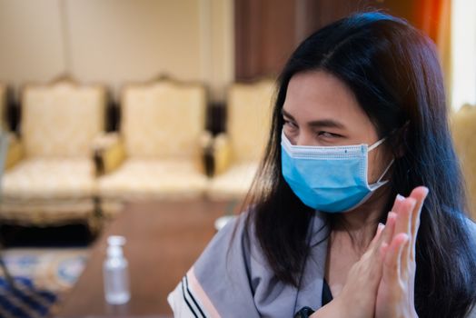 Asian woman wearing mask and alcohol antibacterial hand gel respiratory protection mask against epidemic flu covid19 or corona virus with fear emotion in concept illness, outbreak, healthcare in life