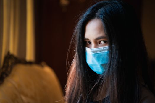 Asian pretty woman wearing mask respiratory protection mask against epidemic flu covid19 or corona virus influenza in office with fear emotion in concept illness, outbreak, healthcare in life