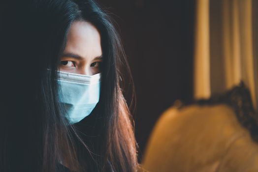 Asian pretty woman wearing mask respiratory protection mask against epidemic flu covid19 or corona virus influenza in office with fear emotion in concept illness, outbreak, healthcare in life