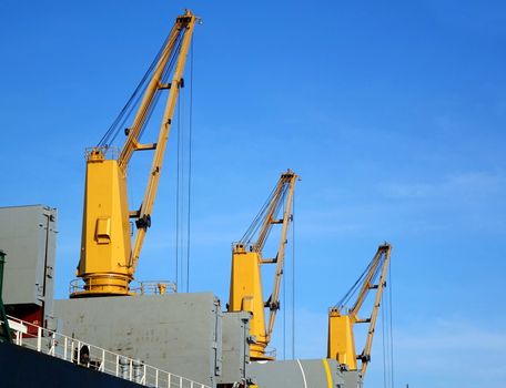 A large ocean-going freight ship with loading cranes

