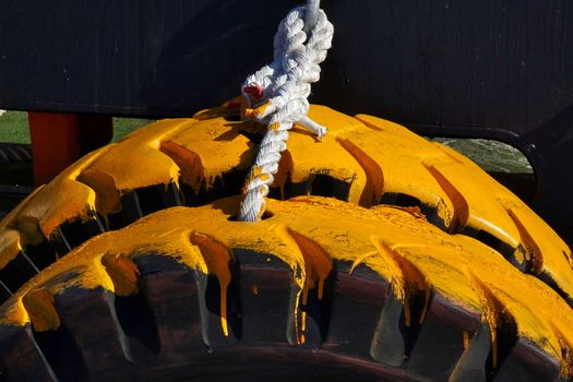 Massive tires are fastened to the hull of a tugboat