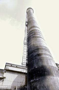 The tall chimney of a deserted factory