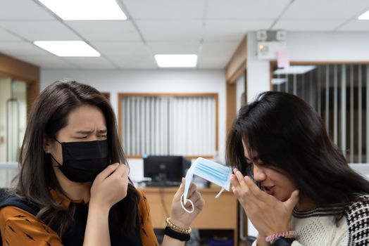 Asian pretty women wearing mask respiratory protection mask against epidemic flu covid19 or corona virus influenza in office with fear emotion in concept illness, outbreak, healthcare in life