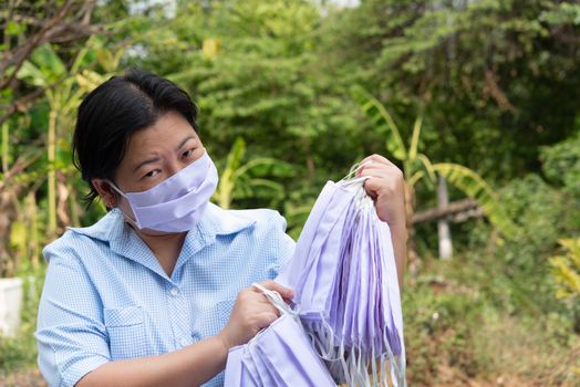 Asian pretty woman wearing mask respiratory protection mask against epidemic flu covid19 or corona virus influenza in office with fear emotion in concept illness, outbreak, healthcare in life