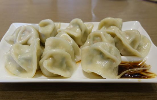A plate of Chinese vegetarian with fresh ginger and sauce
