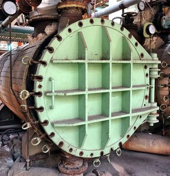 Large industrial boiler in a deserted factory building