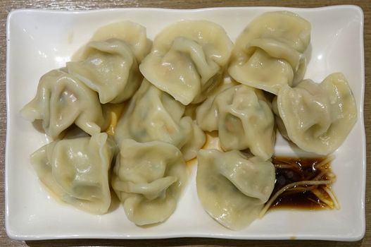 A plate of Chinese vegetarian with fresh ginger and sauce