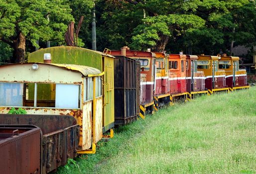 Old industrial diesel train with several carriages
