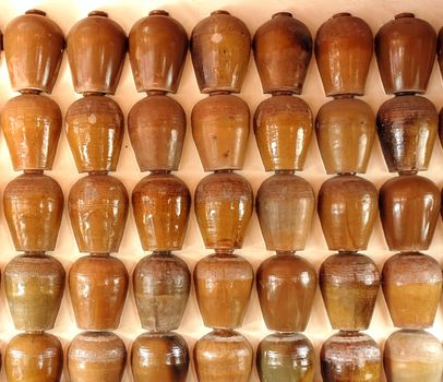 A wall decorated with a pattern of ceramic vessels
