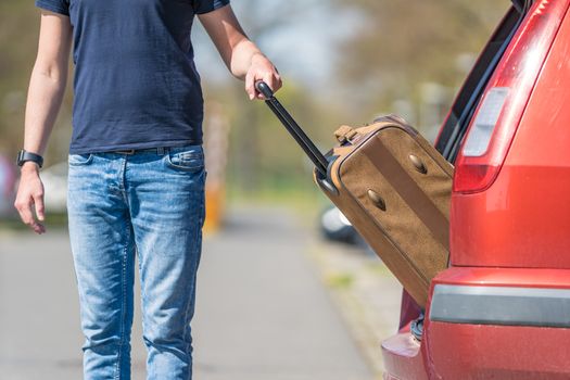 suitcase in hand, the young man pulled from the trunk passenger automobile.