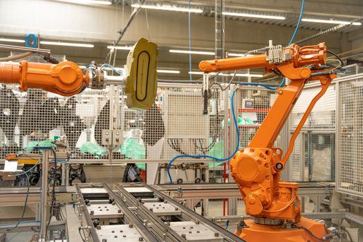 robotic automatic arm in the factory for precise production and joining of individual parts into a whole. robotization production, industry 4.0