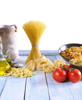 Pasta and ingredients on table of kitchen.