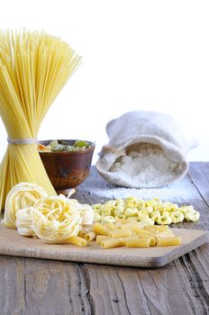 Pasta on a cutting board in a wooden table.