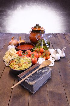 Cookbook over the kitchen table with ingredients.