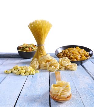 Pasta on a wooden table of kitchen.