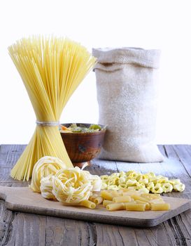 Pasta in a wooden table of kitchen.