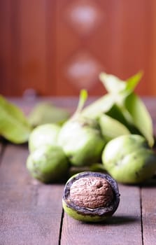 Walnuts on wooden table in the kitchen.