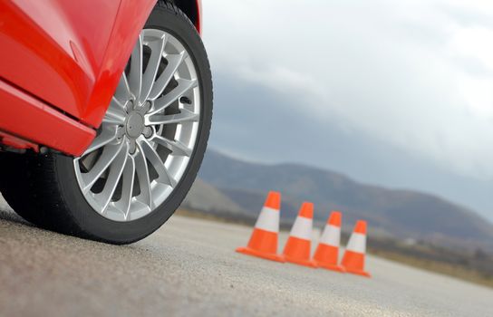aluminium sport wheel and cones, Wheel on a red sport car