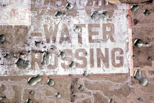Brown grunge background with fading words and droplets