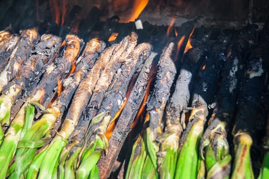 Close-up of huge bunch of traditional catalan calsots or cebollitas de cambray in Mexico prepared on fire