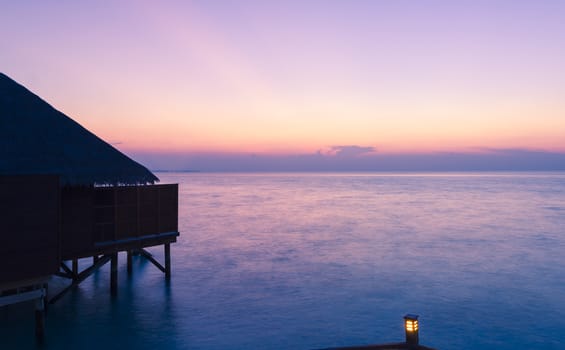 Private villa from Maldives tropical resort at the blue hour. Suitable for an idea of vacations, Caribbean or tropical summer time.