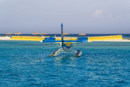 Private seaplane or hydroplane on the ocean lagoon in one of the Maldives islands.