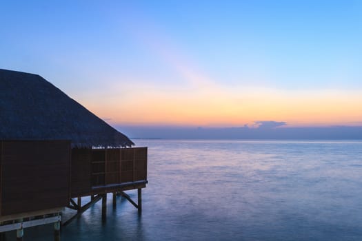 a Maldives tropical resort at the blue hour. Suitable for an idea of vacations, Caribbean or tropical summer time.