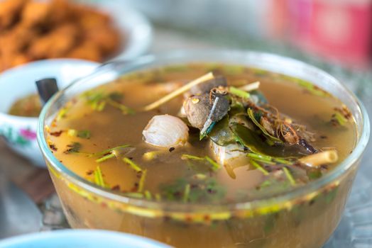 Hot and sour seafood soup (Tom Yum) for sale at Thai street food market or restaurant in Thailand