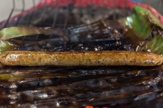 Roasted or Grilled Notrhern Thai Spicy Sausage (Sai Aua) for sale at Thai street food market or restaurant in Thailand