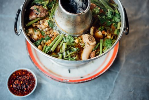 Braised beef clear with meat tendon soup stew (Ekaehla meat) with vegetable in hot pot for sale at Thai street food market or restaurant in Thailand