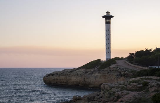 Sunset view of torredembarra's beacon. Mediterranean sea in Tarragona, Spain