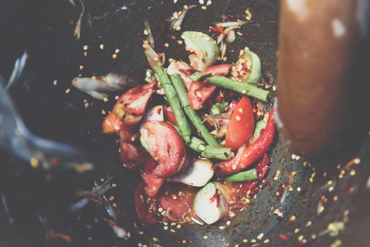 Papaya salad or Papaya Pok Pok (Som tum) for sale at Thai street food market or restaurant in Thailand