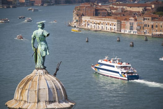 Aerial view of Venice lagoon and San Giorgio Maggiore dome with statue from the top of Campanile