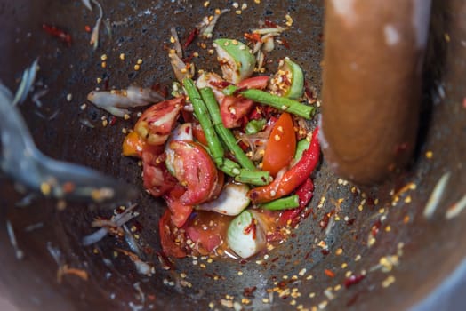 Papaya salad or Papaya Pok Pok (Som tum) for sale at Thai street food market or restaurant in Thailand