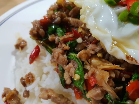 Rice topped with stir-fried pork or beef and basil for sale at Thai street food market or restaurant in Bangkok Thailand