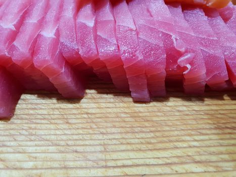 Japanese food delicacy consisting sashimi salmon of very fresh raw salmon fish sliced into thin pieces serving with radish sliced in japanese restaurant