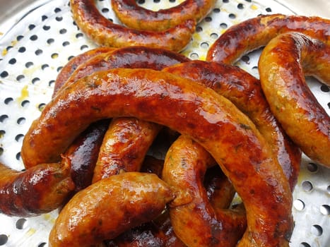 Roasted or Grilled Notrhern Thai Spicy Sausage (Sai Aua) for sale at Thai street food market or restaurant in Thailand