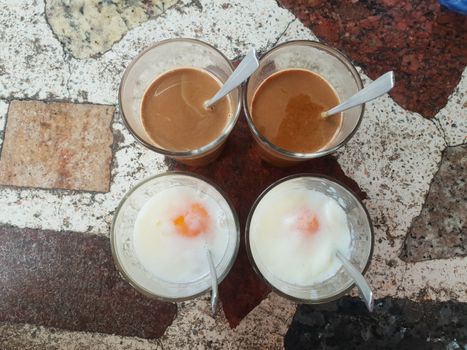 Breakfast food with soft-boiled eggs and vintage coffee Thai style for sale at Thai street food market or Thai vintage style coffee shop restaurant in Thailand