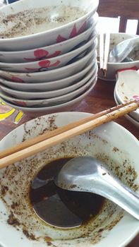 Braised beef clear noodle with meat balls soup stew (Ekaehla meat) with vegetable in bowl for sale at Thai street food market or restaurant in Thailand