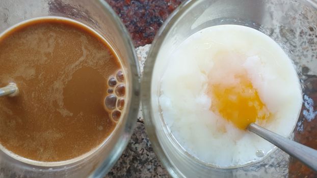 Breakfast food with soft-boiled eggs and vintage coffee Thai style for sale at Thai street food market or Thai vintage style coffee shop restaurant in Thailand