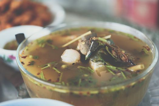 Hot and sour seafood soup (Tom Yum) for sale at Thai street food market or restaurant in Thailand